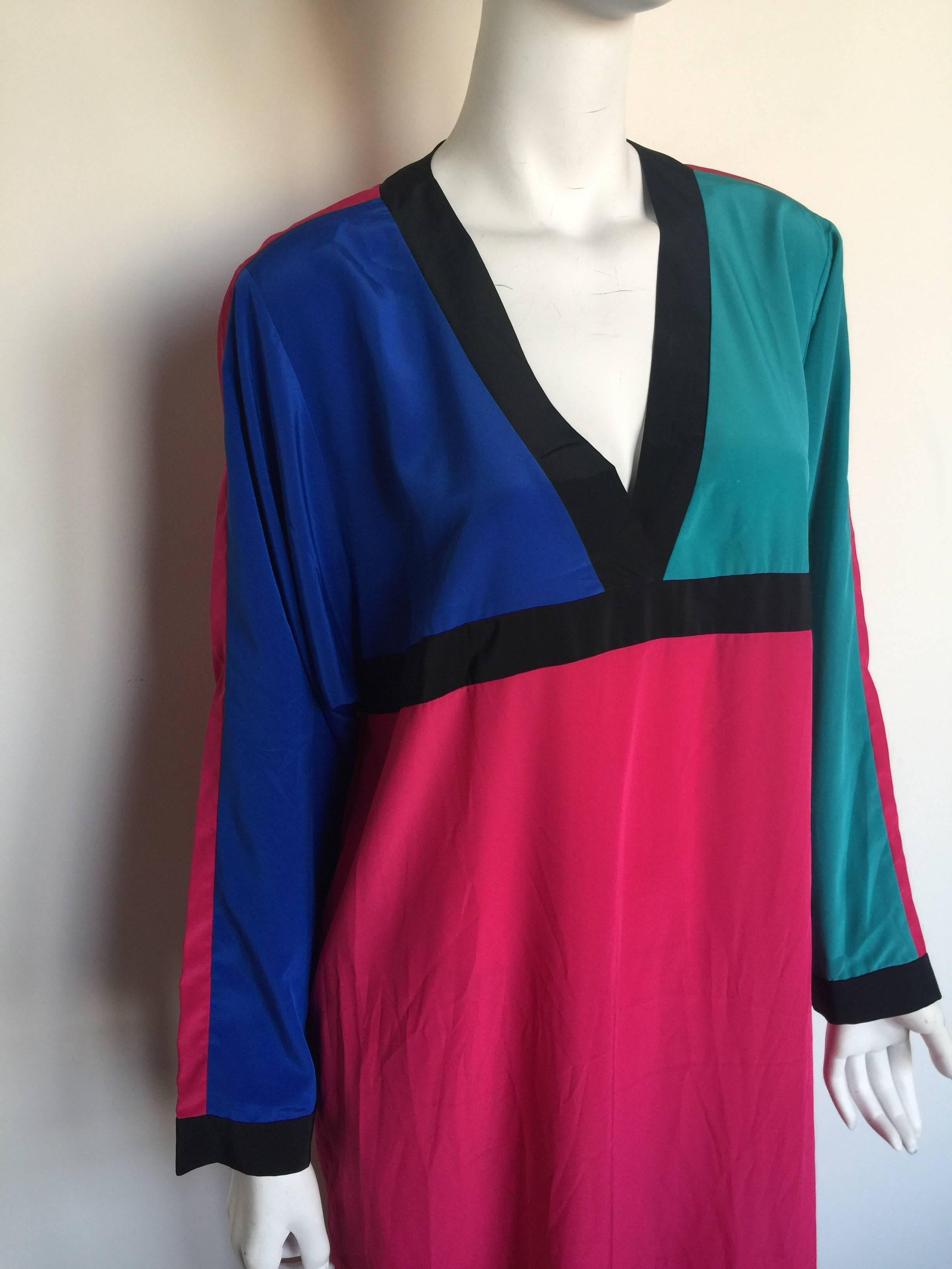 This Oscar de la Renta swim is a cover up kaftan.  It is bright pink, purple and teal color block.  It is labelled a size L