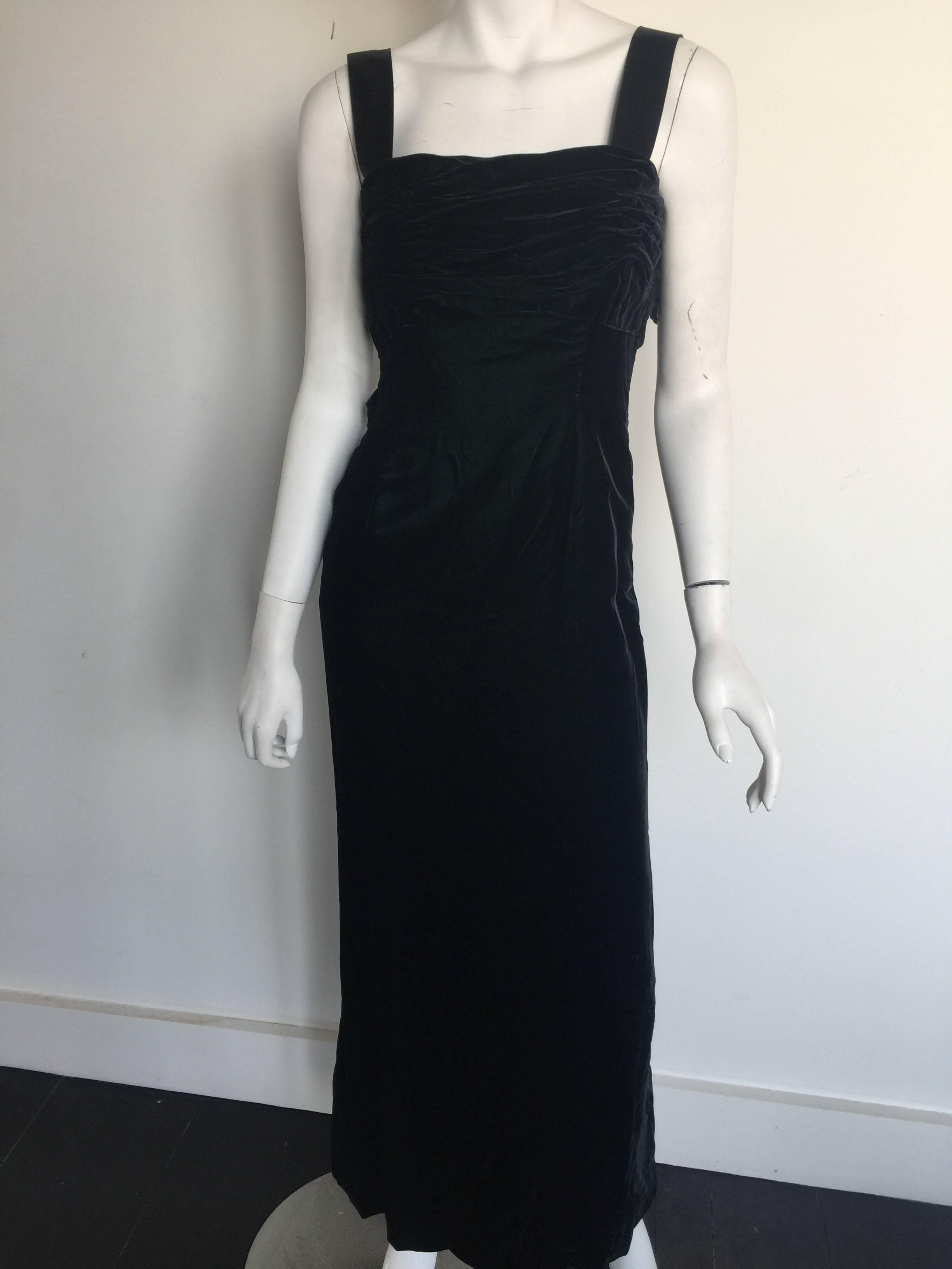 This dark green velvet dress almost looks black.  It has a ruched velvet chest and a form fitting cut.  It has thick grosgrain straps with plenty of room to be taken out or taken off even.  Two small bows on the back which can also be easily removed