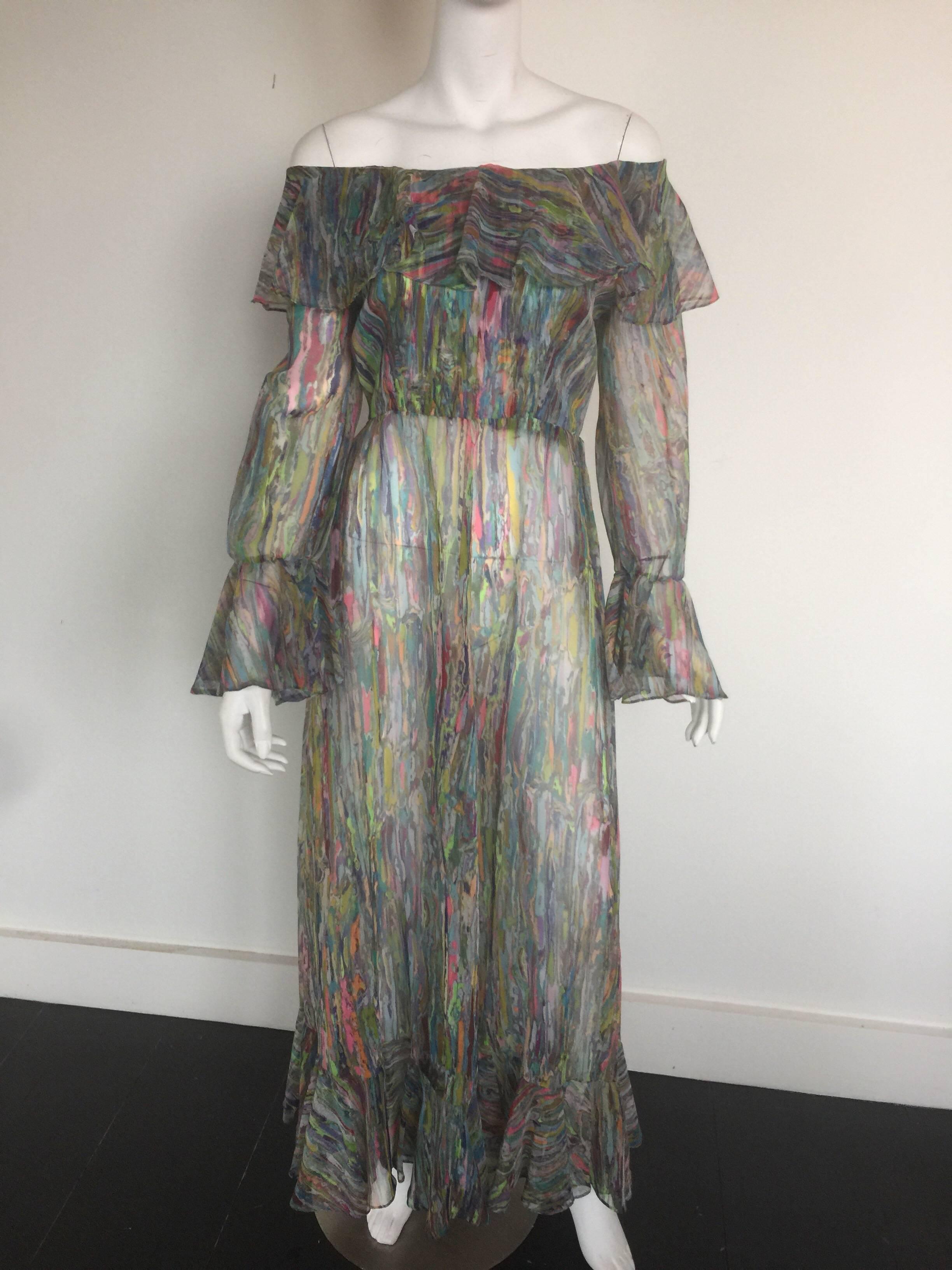 An original Multi colored wood grain Maxi dress with a boat neckline and a beautiful ruffle along the top which covers most of the top. Long poet sleeves with a high waist set on to a long skirt ending with ruffles located on the hemline.The dress