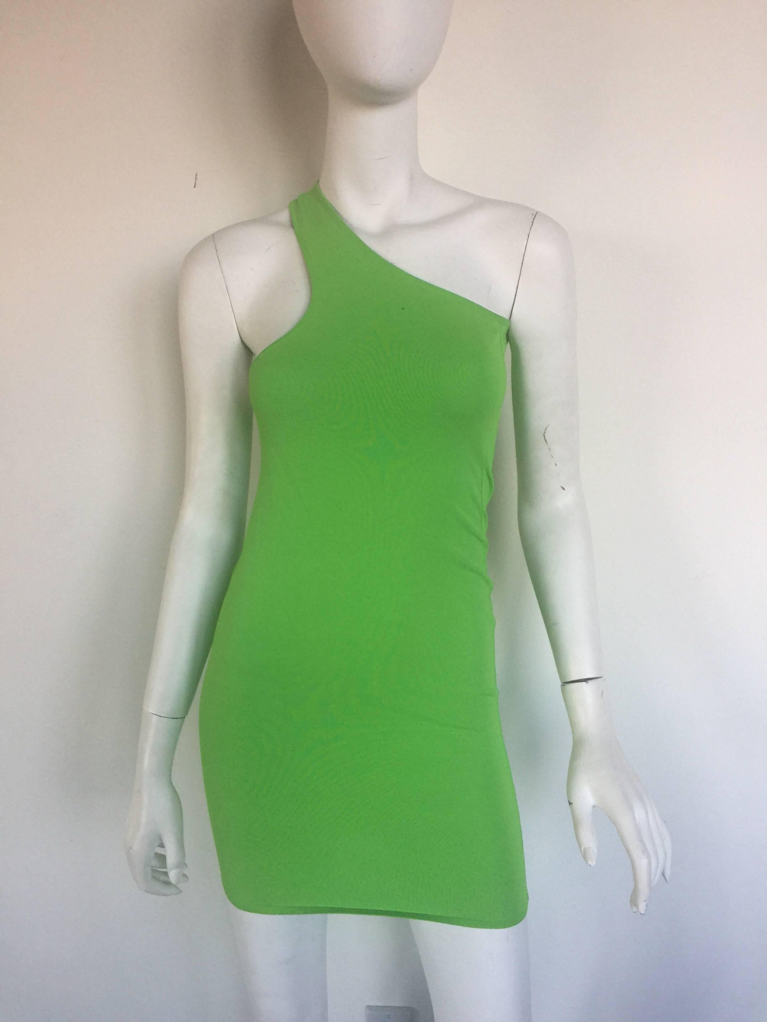 This classic Gianni Versace bandage mini dress is lime green.  It has a one shoulder cut out style top and one or two small snags in fabric but overall in great condition.  It is a size 38/4.