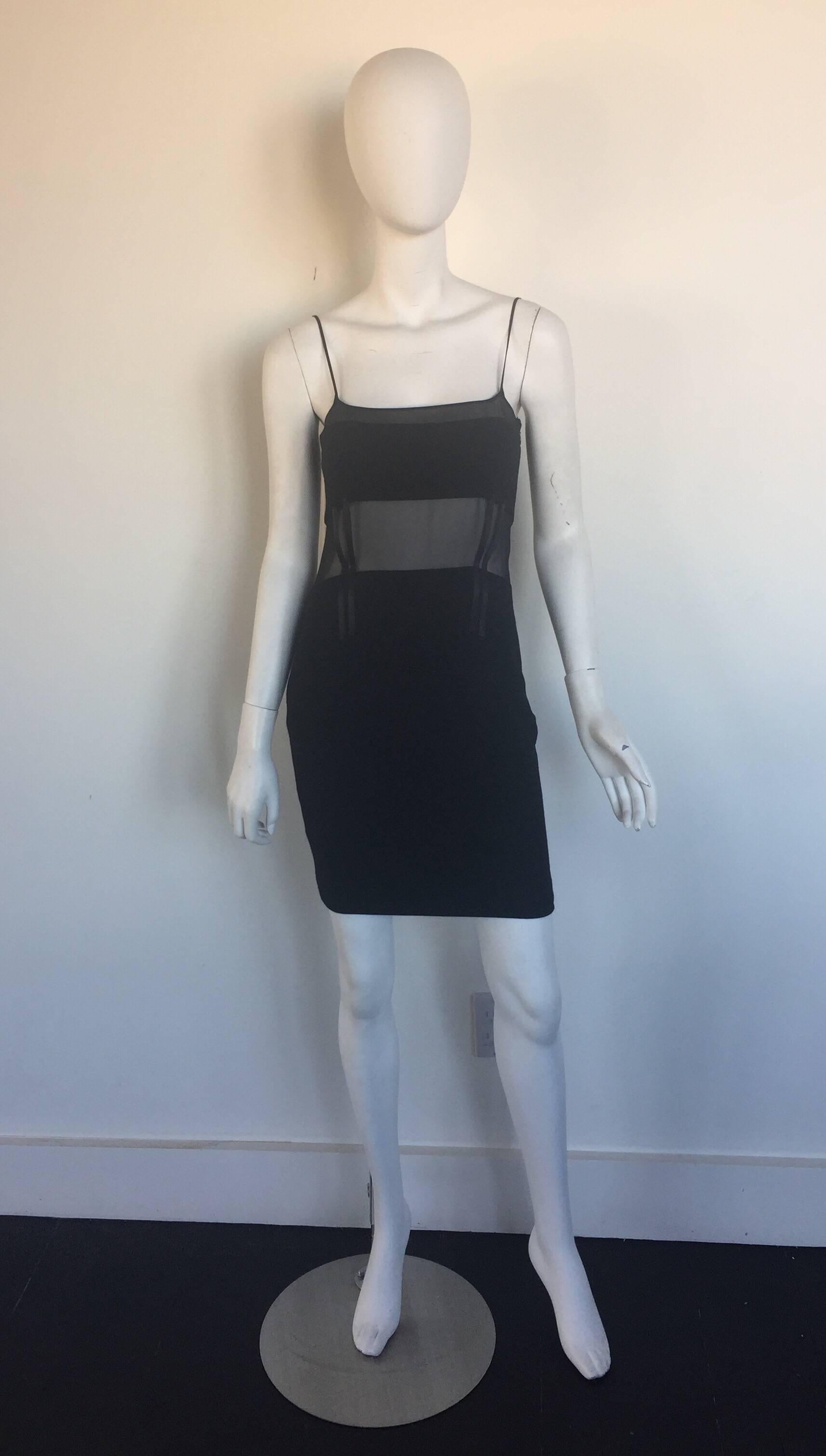 This sheer panel Versace dress has corset boning and a little elastic in the wool fabric skirt.  It is a size 40 but fits a small.  It has a little pulling on one seem but not very noticeable. 