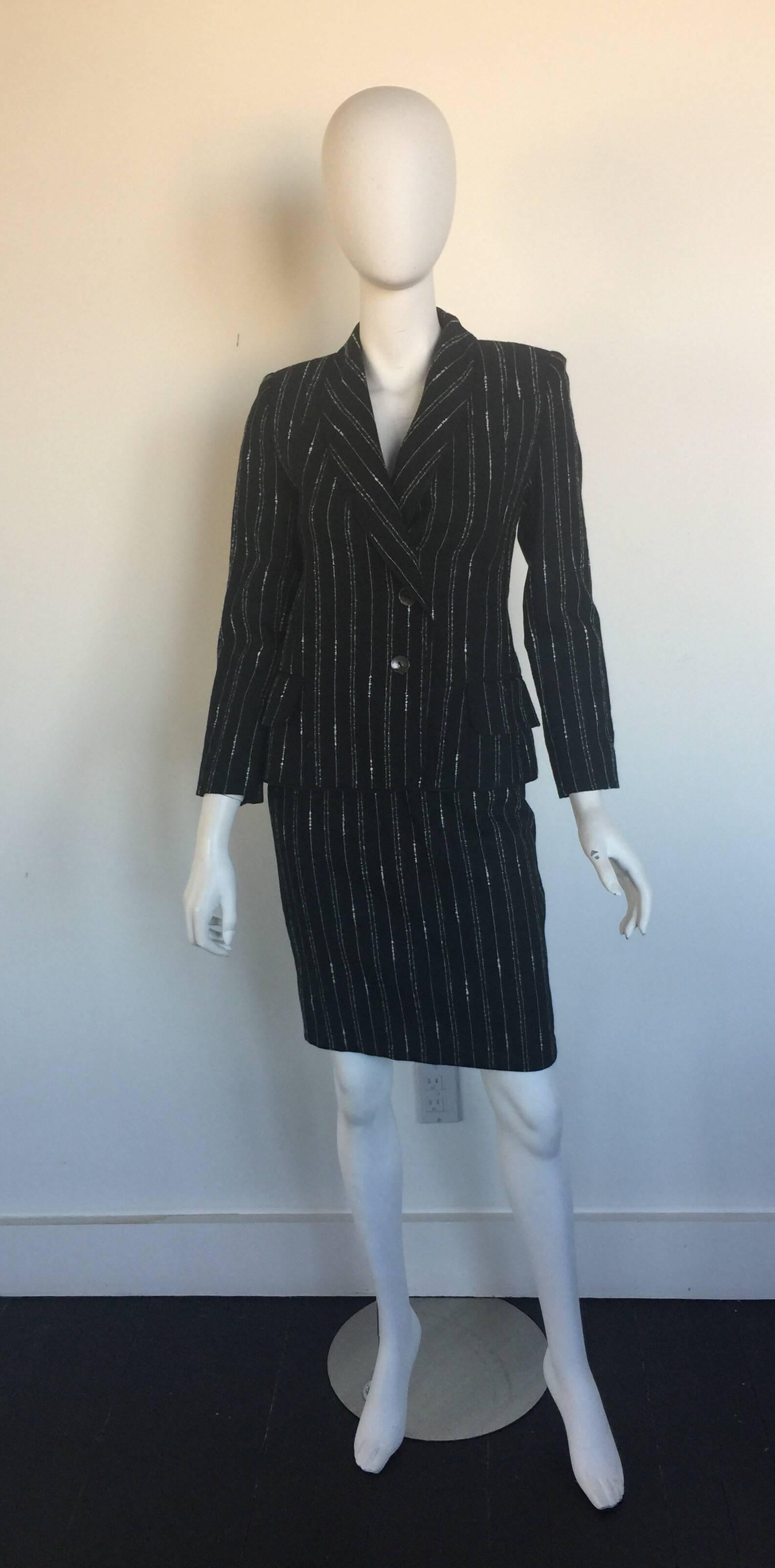 This Givenchy skirt suit is 100% wool and not labelled a size but fits a small and is most likely from the 1990s.  It has a small rip on the front of the jacket as pictured and priced accordingly. 