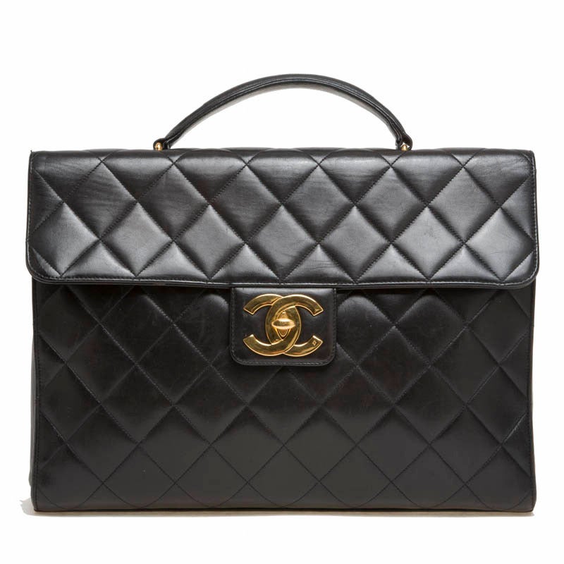 This ultra sophisticated Chanel Vintage Lambskin Briefcase in Large is a must-have for any fashionable professional. It is designed with the signature Chanel diamond quilt pattern. This beautiful black briefcase features a CC turn-lock closure and