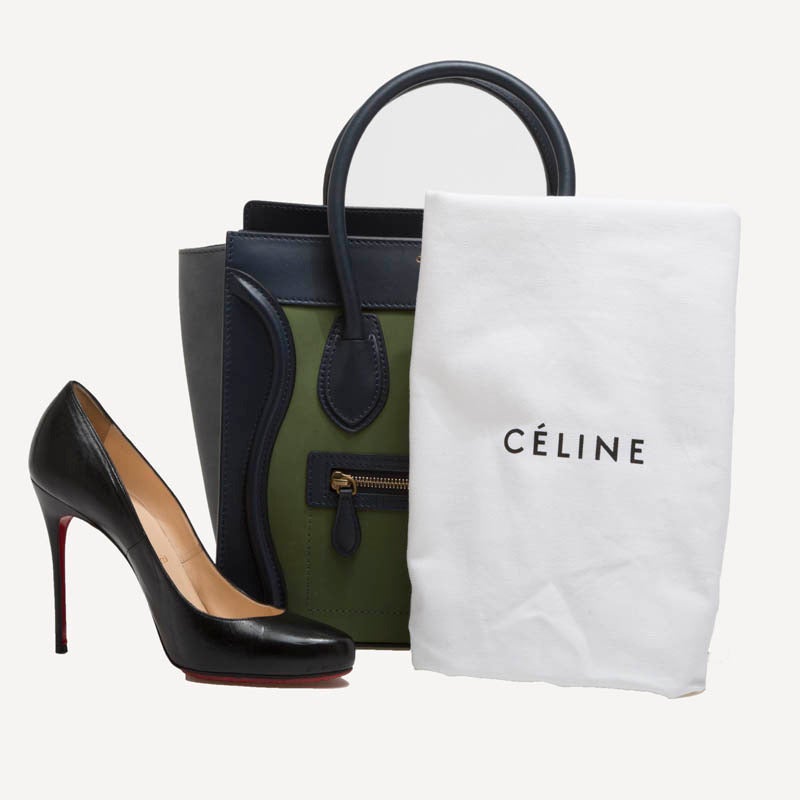 This alluring Celine Luggage Tricolor Micro Bag is the quintessential It bag. Its beautiful rich tones of olive green and navy blues, are accented with gold hardware and all-around detailed stitching. The front face features smooth calfskin leather