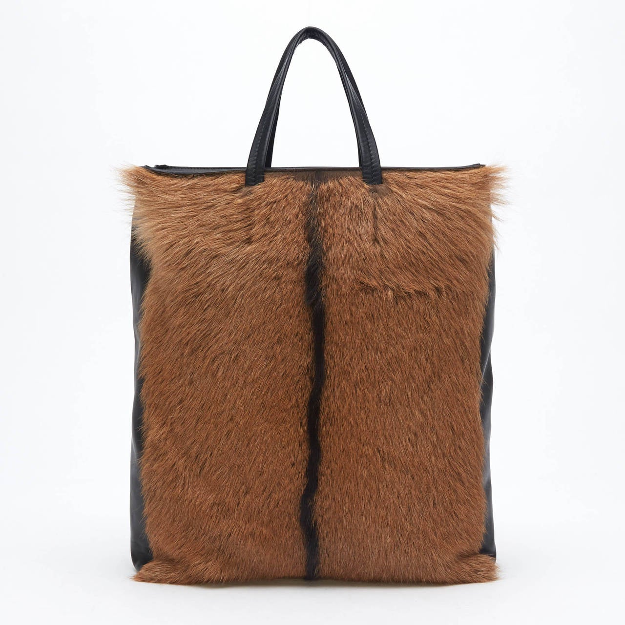 This stunning, rich Celine Cabas Fur Vertical Tote is sure to turn heads. This bag represents class and fashion. The rich soft brown and chocolate fur is paralleled with soft calfskin leather. The bag also features two leather handles and an