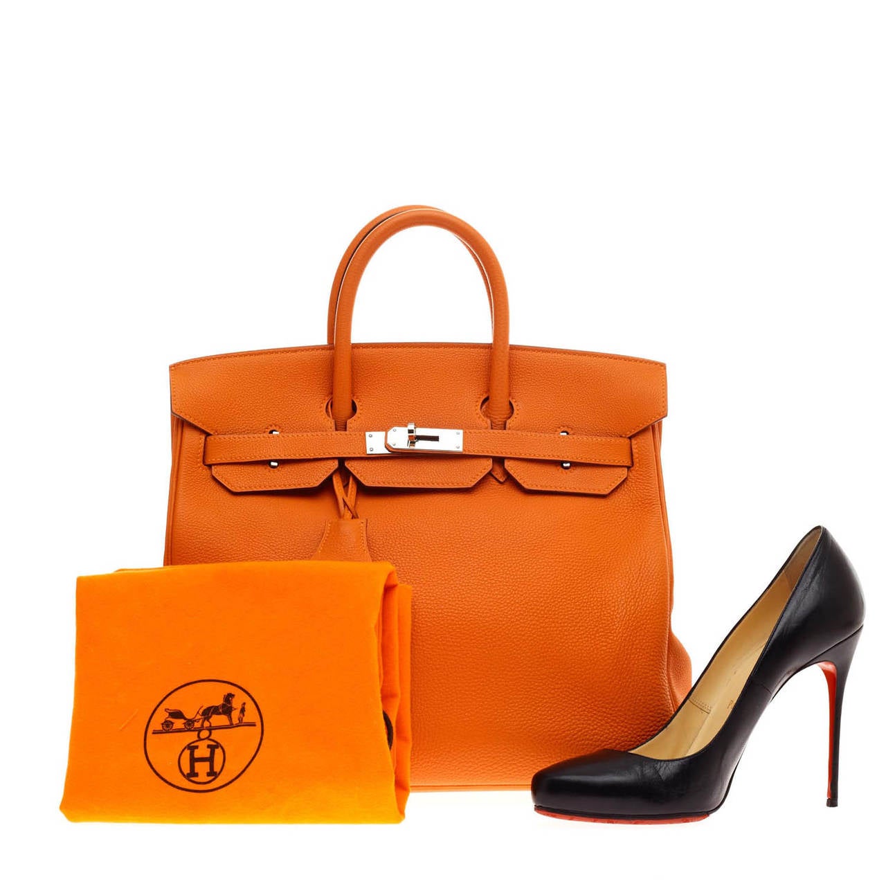 This authentic Hermes HAC Birkin Togo 32 in vibrant Orange is synonymous to traditional Hermes luxury. The HAC, modeled after regular Birkins stands at taller proportions with slightly shorter handles giving it its own distinct style. Accented with