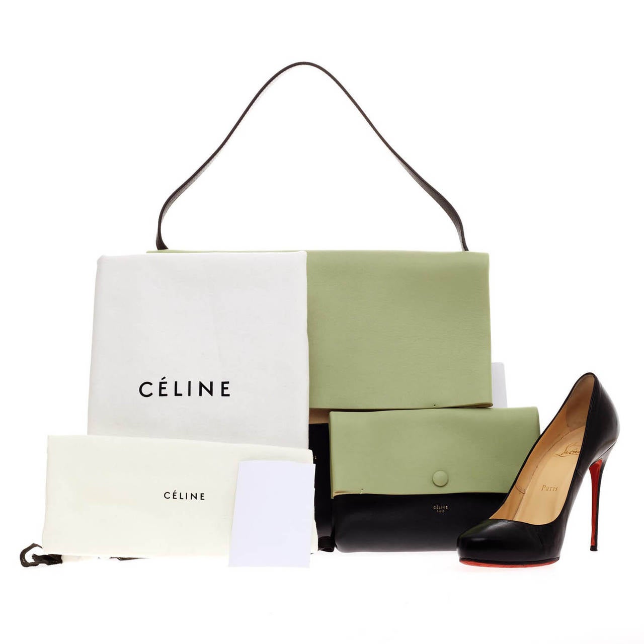 This authentic Celine All Soft Shoulder is designed in mint green, taupe and black color block calfskin leather for a neutral and understated look. The exterior of the bag is made of soft, buttery leather with a tan suede panel under the front flap.