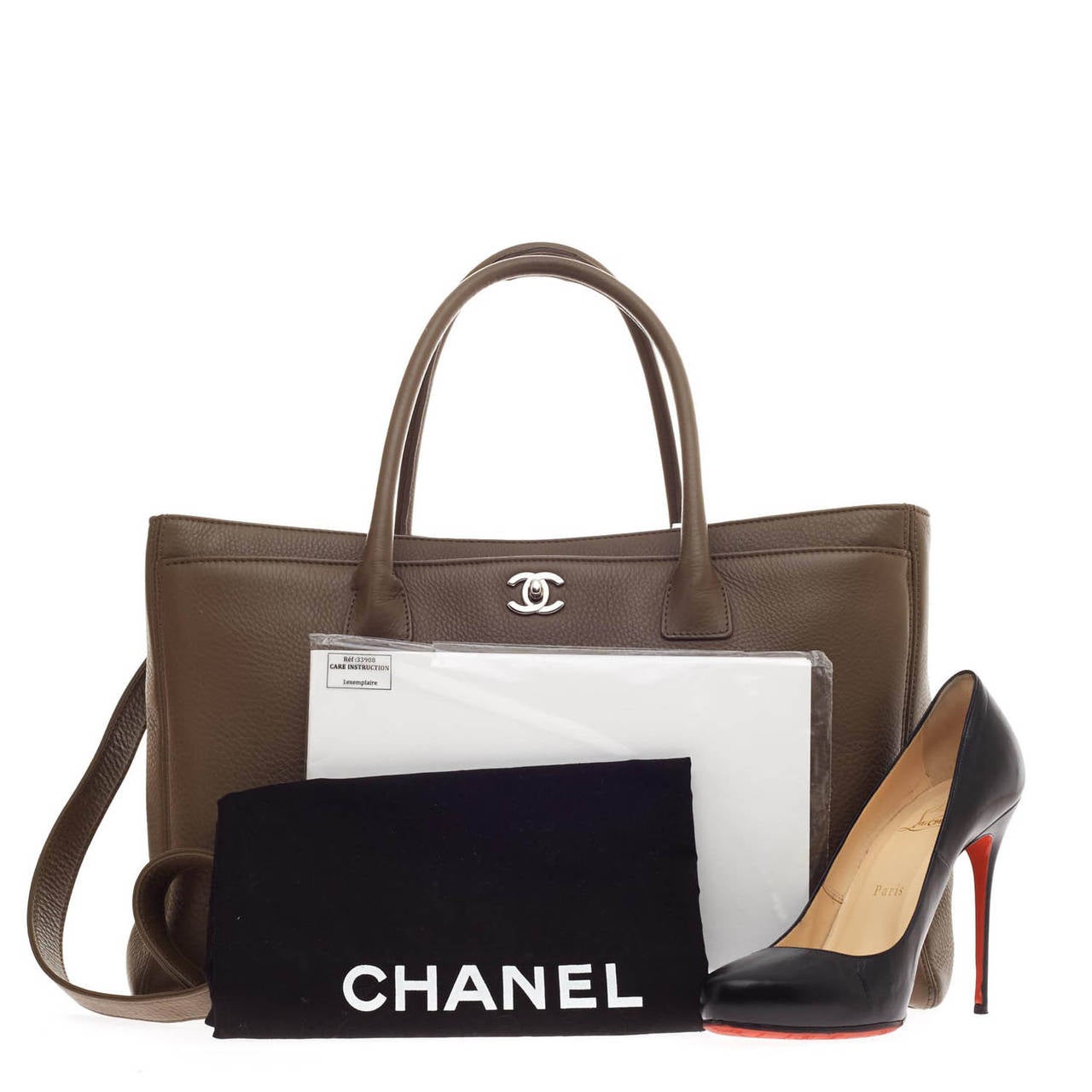 This authentic Chanel Cerf Executive Tote in beautiful dark taupe pebbled leather is ideal for the modern woman as it can be dressed up or down. Its classic boxy silhouette, roomy lined grey interior and removable shoulder strap enables it to go