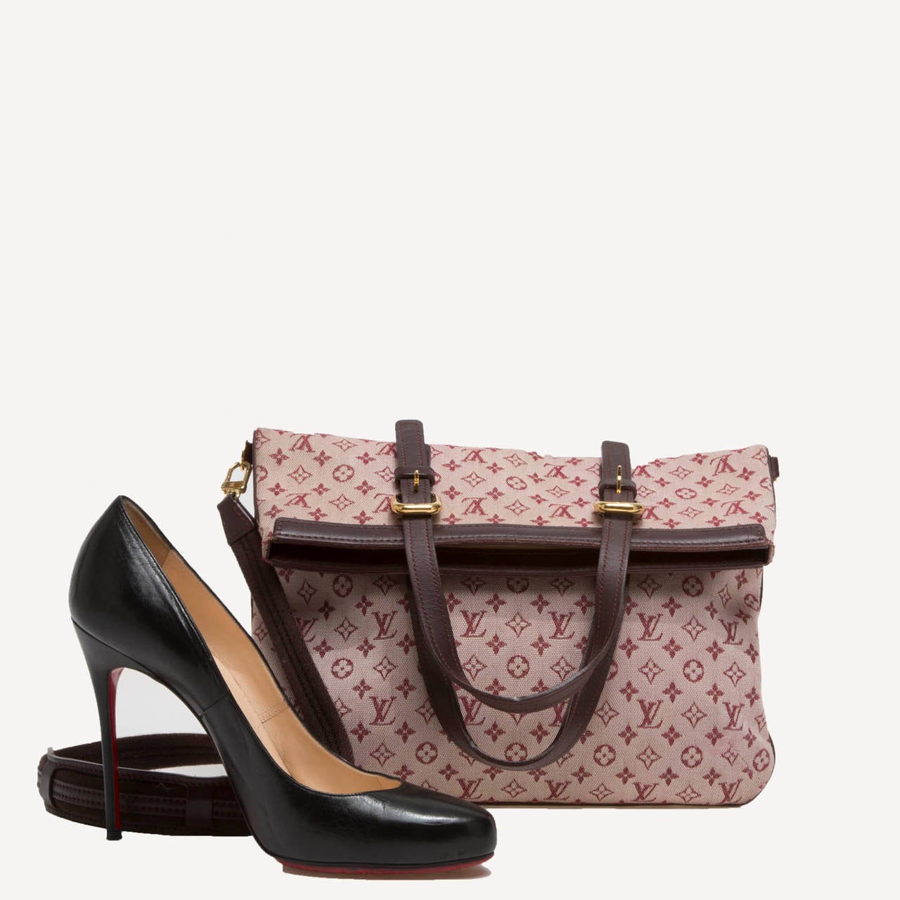 This authentic Louis Vuitton Francoise features the brand's sporty monogram Mini Lin canvas print in burgundy motif. The lightweight canvas with leather trims, removable shoulder strap and top handles allows this bag for versatility. The Francoise