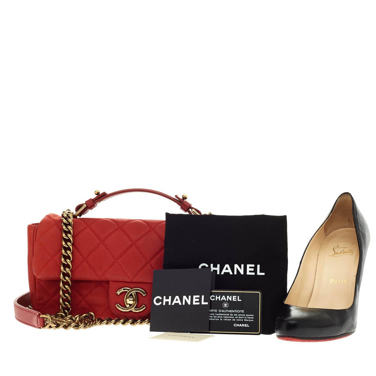 Debuting at Chanel's Pre-Spring 2013 Collection, this authentic Chanel Chic Quilt Flap in size Small in stunning muted red caviar is a modern twist to the classic Chanel design. Designed with a top handle and aged brass leather chain straps, this