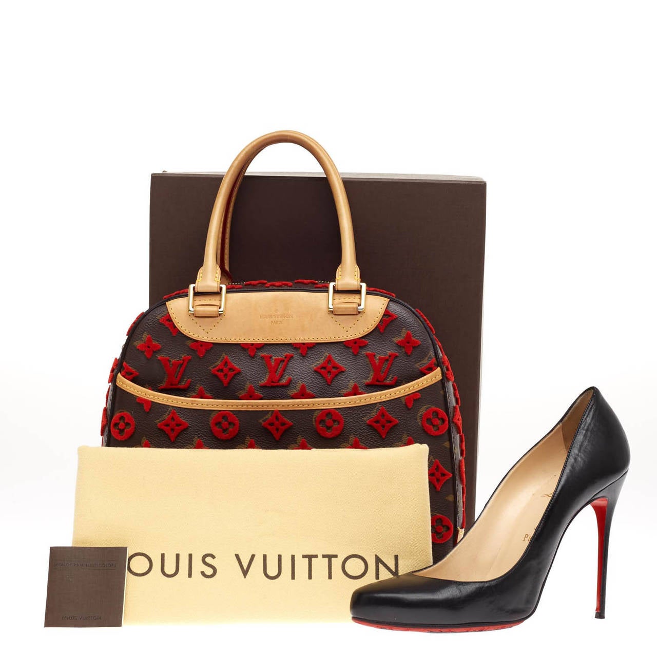 This authentic Louis Vuitton Deauville Cube Bag Limited Edition Monogram Canvas Tuffetage is a modern and unique twist on a timeless luxury brand. This limited edition tote from the Pre-Fall 2013 season is constructed of classic Louis Vuitton