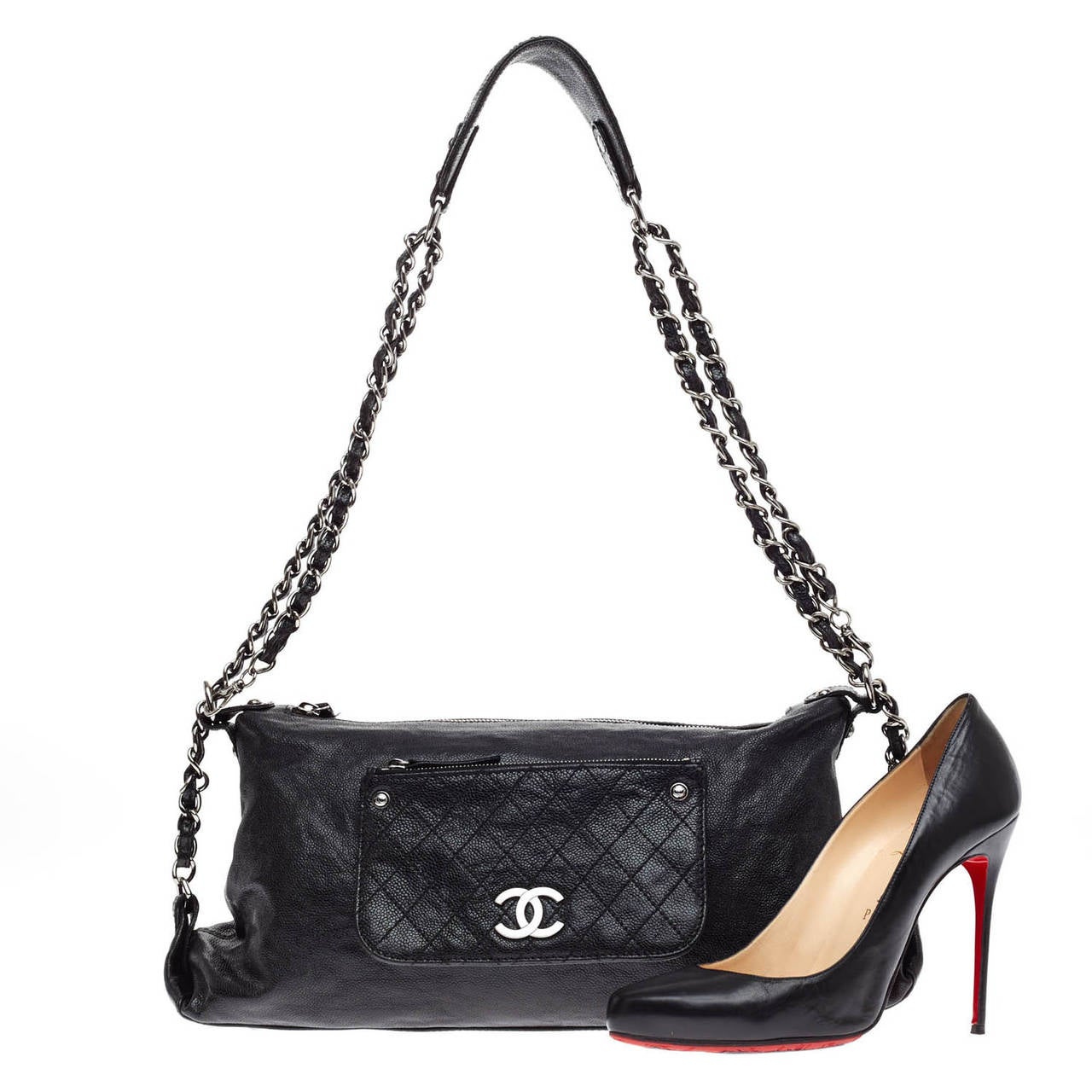 This authentic Chanel Pocket in the City Caviar Shoulder Bag in classic black features a unique diamond quilted patch zipped pocket design at the front face and dual adjustable black woven-in silver chain straps with leather shoulder pad. This