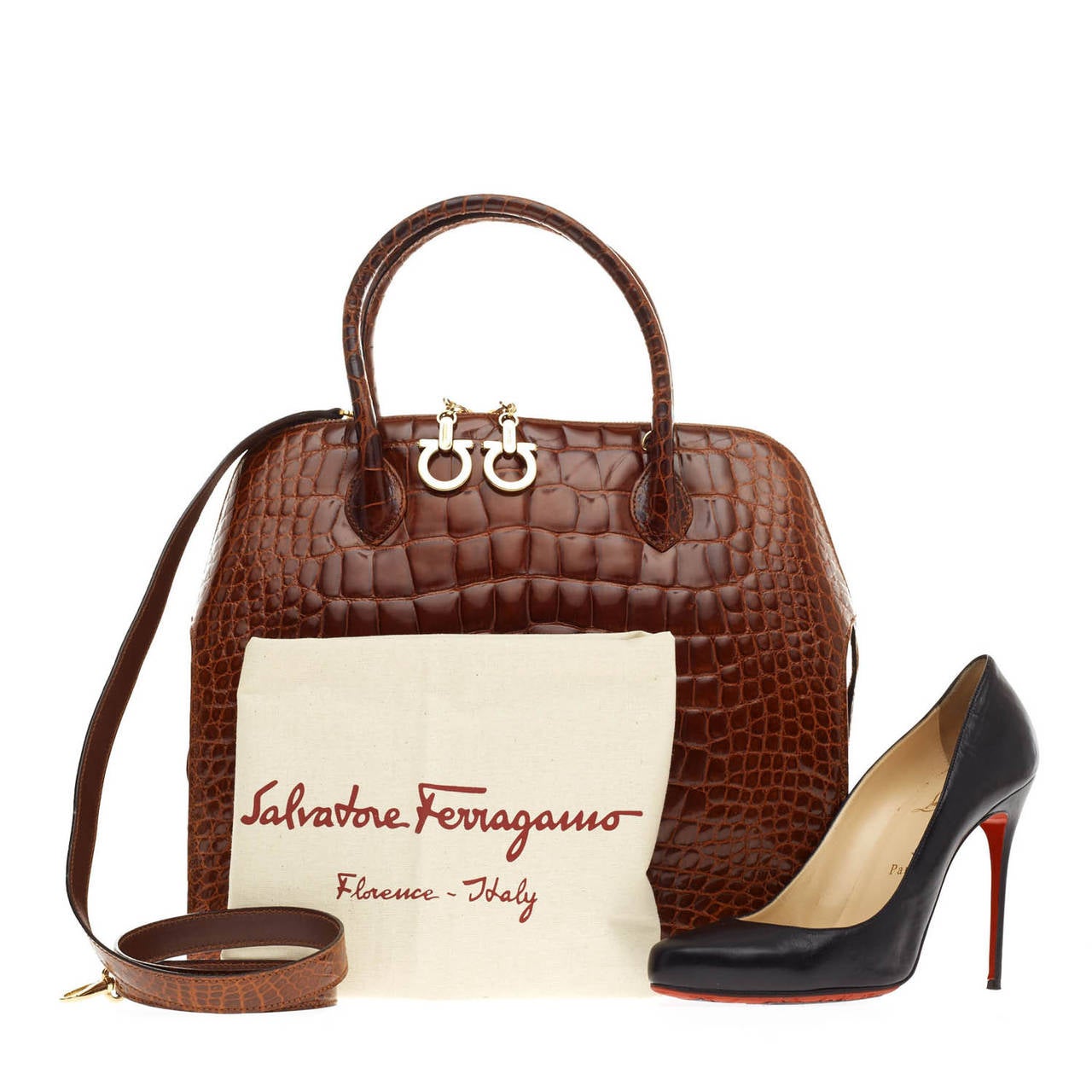 This authentic Salvatore Ferragamo Zip Frame Bag Alligator in Large is a classic and luxurious piece crafted of alligator skin. This sturdy handbag zips around the frame with oversize gold tone Gancini hardware and four protective studs at the base.