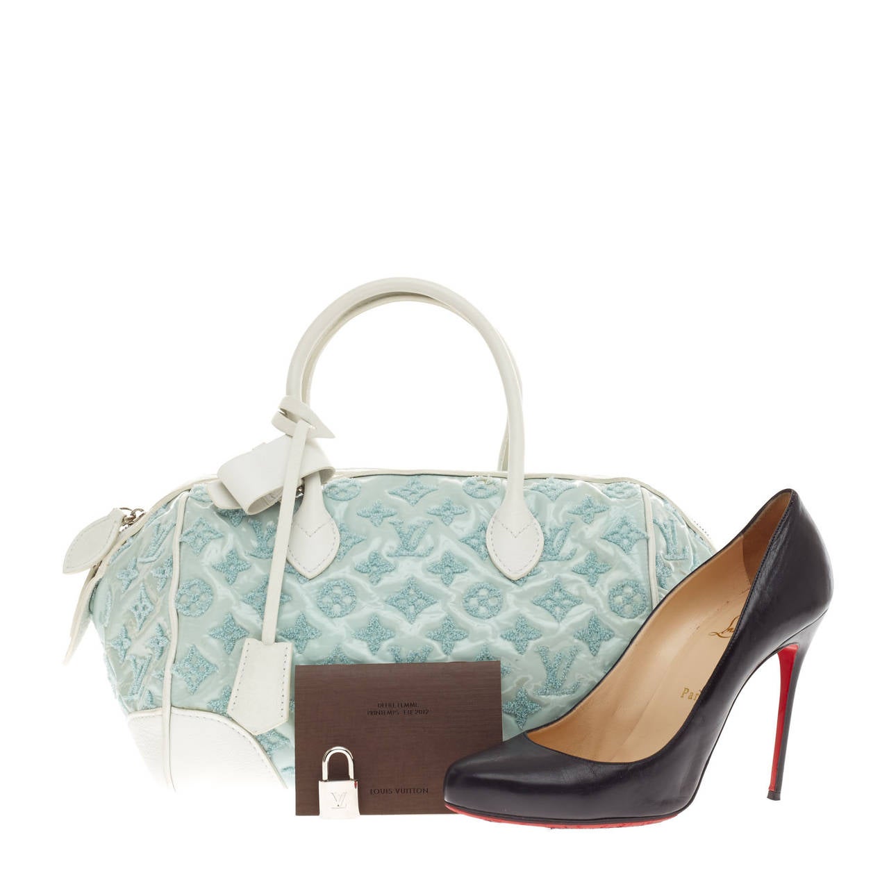 This authentic Louis Vuitton Round Speedy Monogram Bouclettes in Mint is great for everyday wear and perfect for spring season. This Spring/Summer 2012 Limited Edition design features an embroidered monogram pattern on a pastel blue patent leather