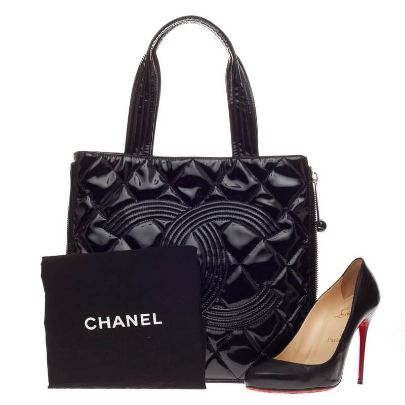 This authentic Chanel Expandable CC Shopping Tote Quilted Patent Medium is ideal for work and day to day looks. Crafted in black quilted patent leather, this versatile tote features dual-flat handles, all-around zipper designs that expands and