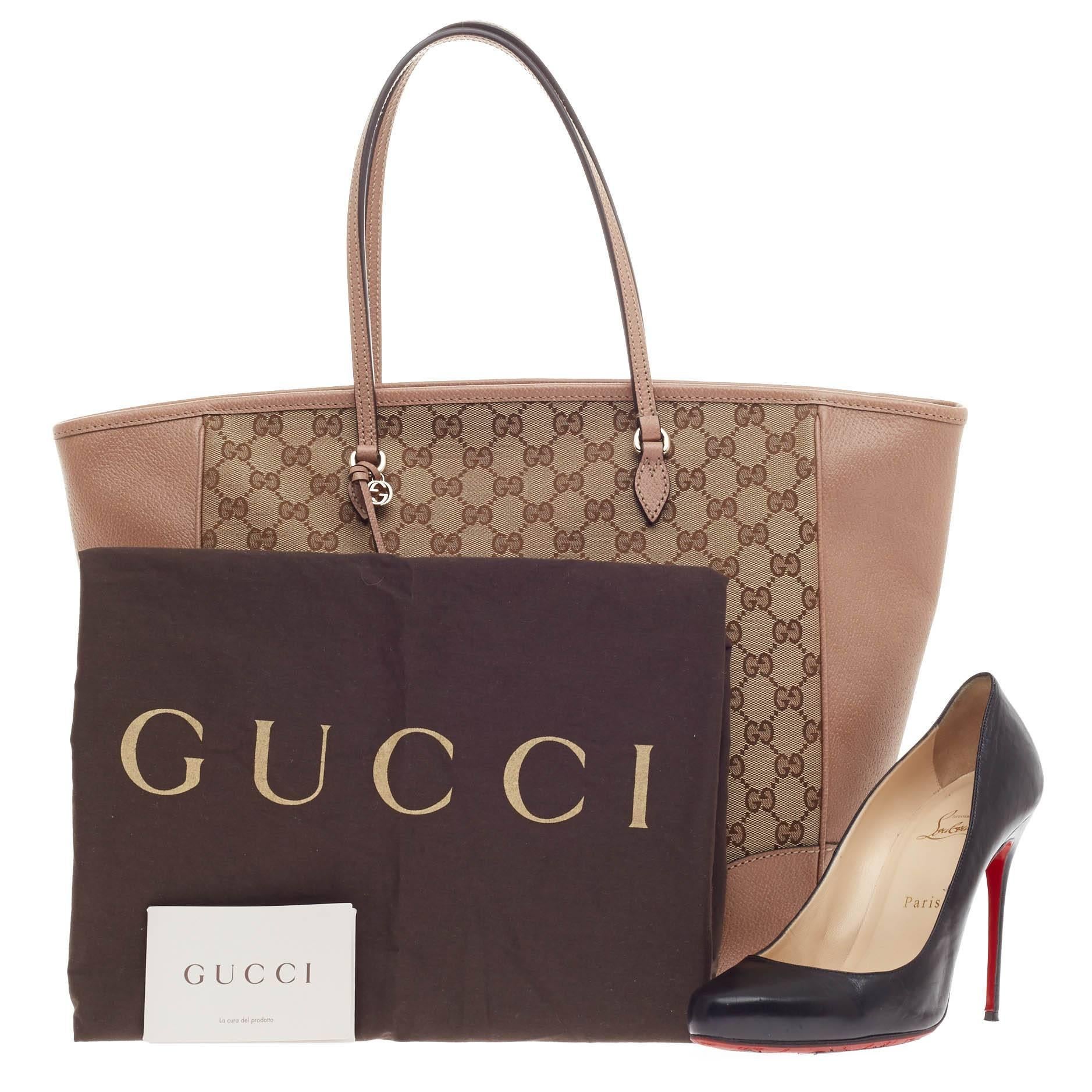 This authentic Gucci Bree Original Tote Leather and GG Canvas Medium is perfect for everyday casual look. Crafted in brown GG canvas with dusty rose leather trims, this simple shopper-style tote features tall slim handles, small Gucci charm and