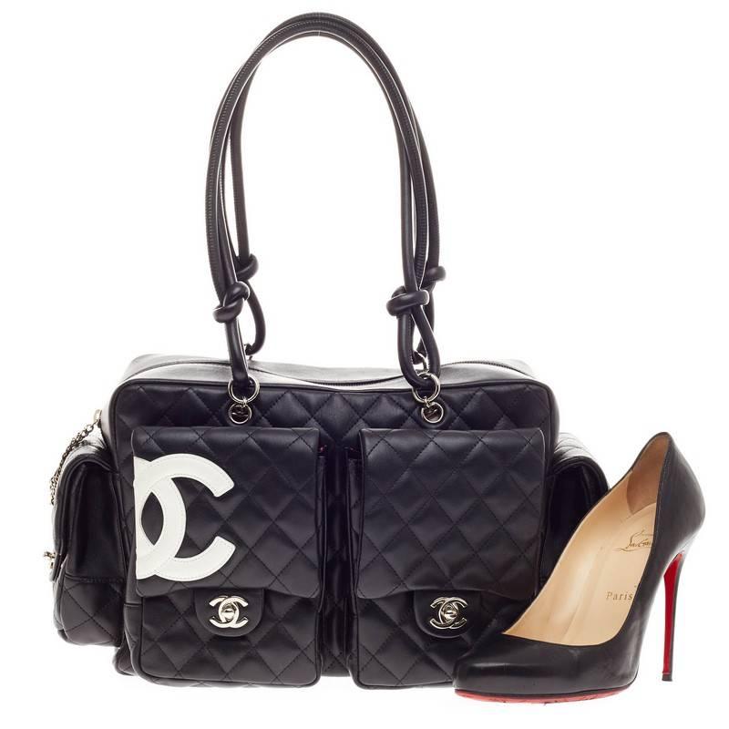 This authentic Chanel Cambon Multipocket Reporter Quilted Lambskin Large in black is a practical bag with a chic and stylish appeal. Constructed with diamond quilted calfskin leather, this bag features facing and side pocket compartments designed