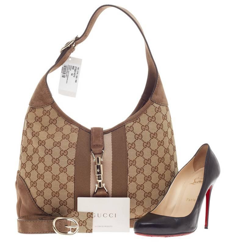 This authentic Gucci Jackie Original Web Shoulder Bag GG Canvas and Nubuck Medium is a must-have versatile shoulder bag fit for the modern woman. Constructed from brown GG canvas with tan nubuck edges and trims, this luxurious, modern interpretation