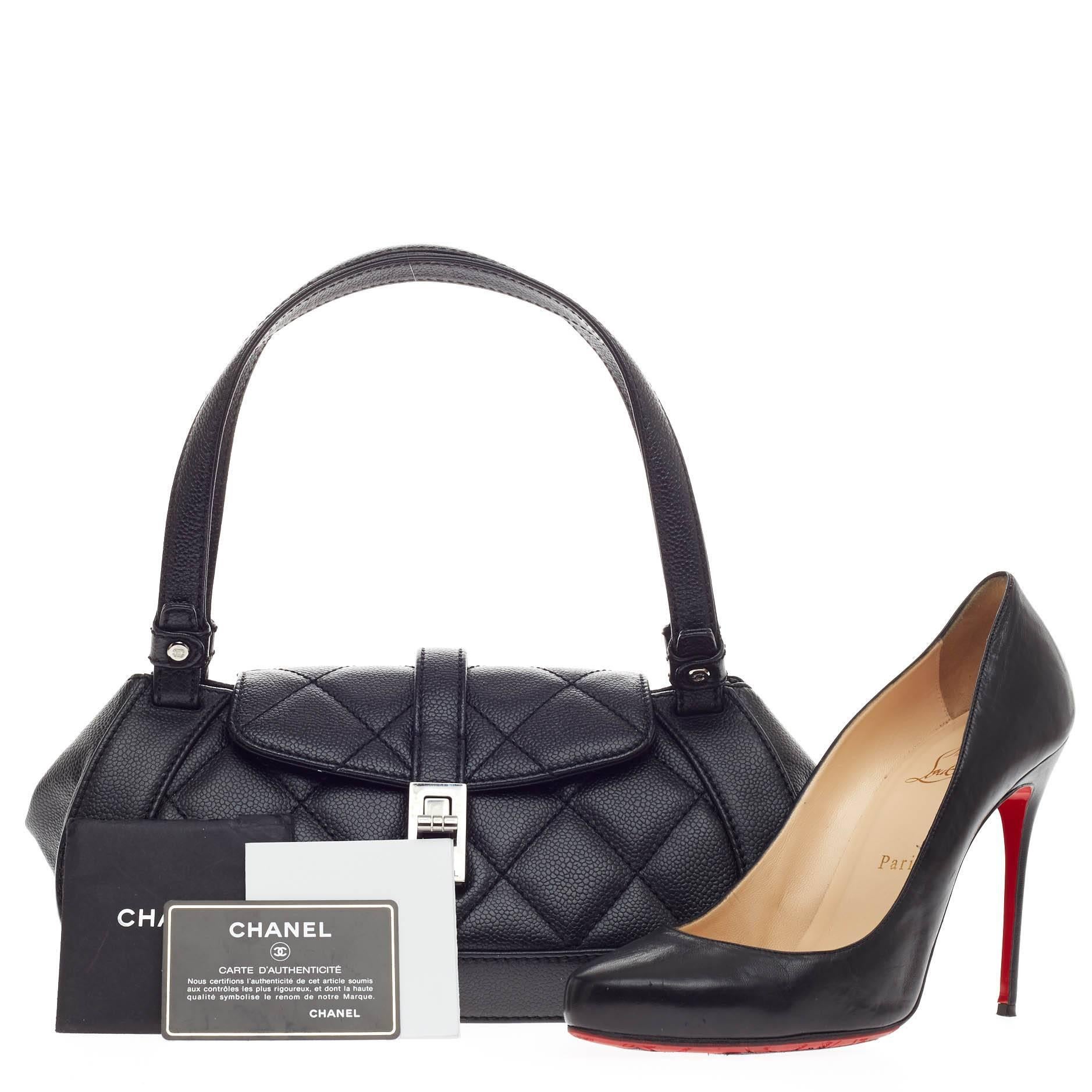 This authentic Chanel Mademoiselle Lock Shoulder Bag Quilted Caviar Small is a luxurious accessory made for casual and daily looks. Crafted in black quilted caviar, this petite bag features a frontal flap, long dual leather handles, protective base