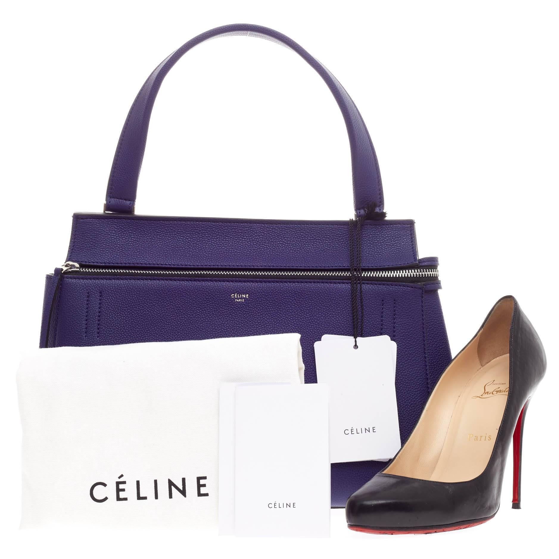 This authentic Celine Edge Bag Leather Small is the quintessential Céline design mixing minimalism with luxury. The bag is crafted with luxurious, eye-catching royal blue grained leather featuring a large silver zip-around closure and back pocket