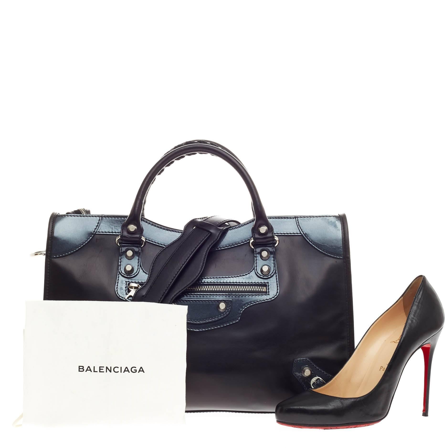 This authentic Balenciaga Holiday City Giant Studs Matte Calfskin Medium presented in designer Alexander Wang's 2015 Holiday Collection takes on a sporty twist. Constructed in structured black matte calfskin leather with black sheen patent leather