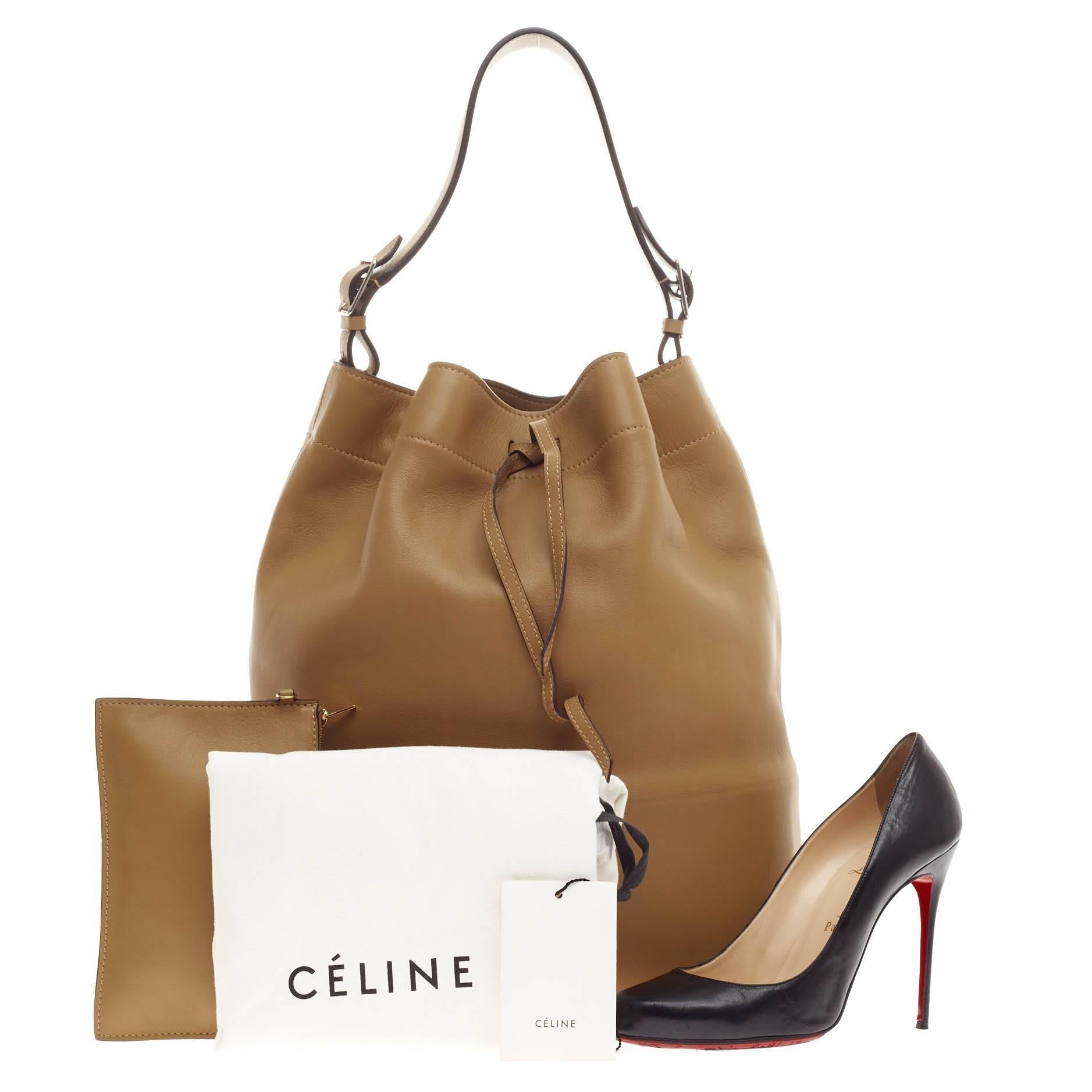 This authentic Celine Seau Drawstring Bag Leather presented in the brand's Fall/Winter 2013 Collection is elegant and sophisticated in style perfect for everyday work. Crafted in supple, tan calfskin leather, this classic, minimalist bucket bag