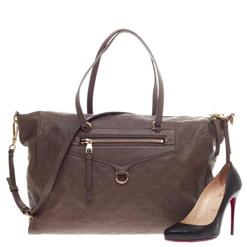 This authentic Louis Vuitton Lumineuse Monogram Empreinte Leather GM showcases everyday sophistication. Crafted in ombre brown monogram empreinte leather, this functional, impeccably stylish tote features an exterior front zip pocket, dual-flat