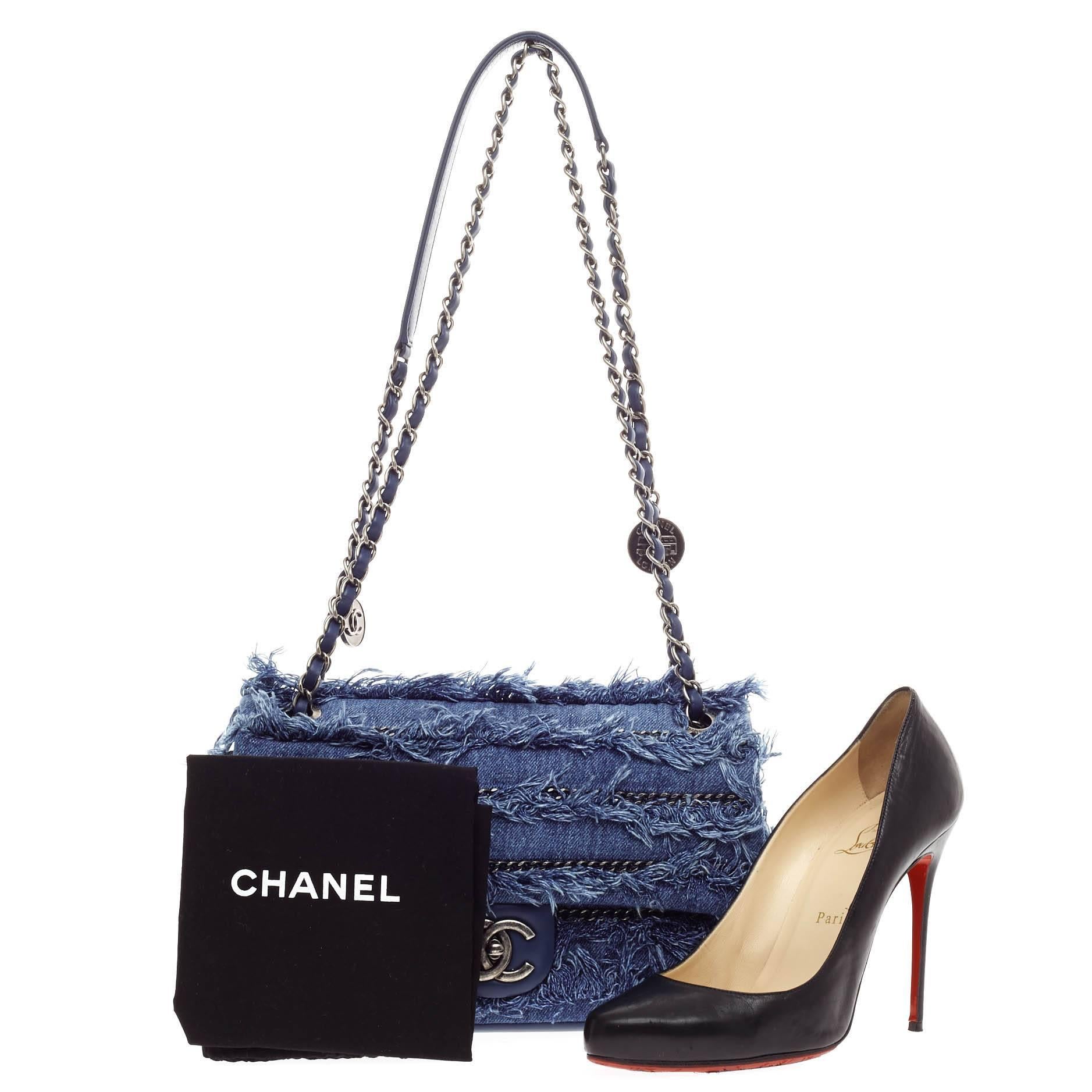This authentic Chanel Medallion Charm Flap Fringe Denim Medium from the brand's Cruise 2015 collection held in Dubai updated its classic design with meticulous design in a retro-inspired theme. Crafted in washed layered denim with intricate fringe
