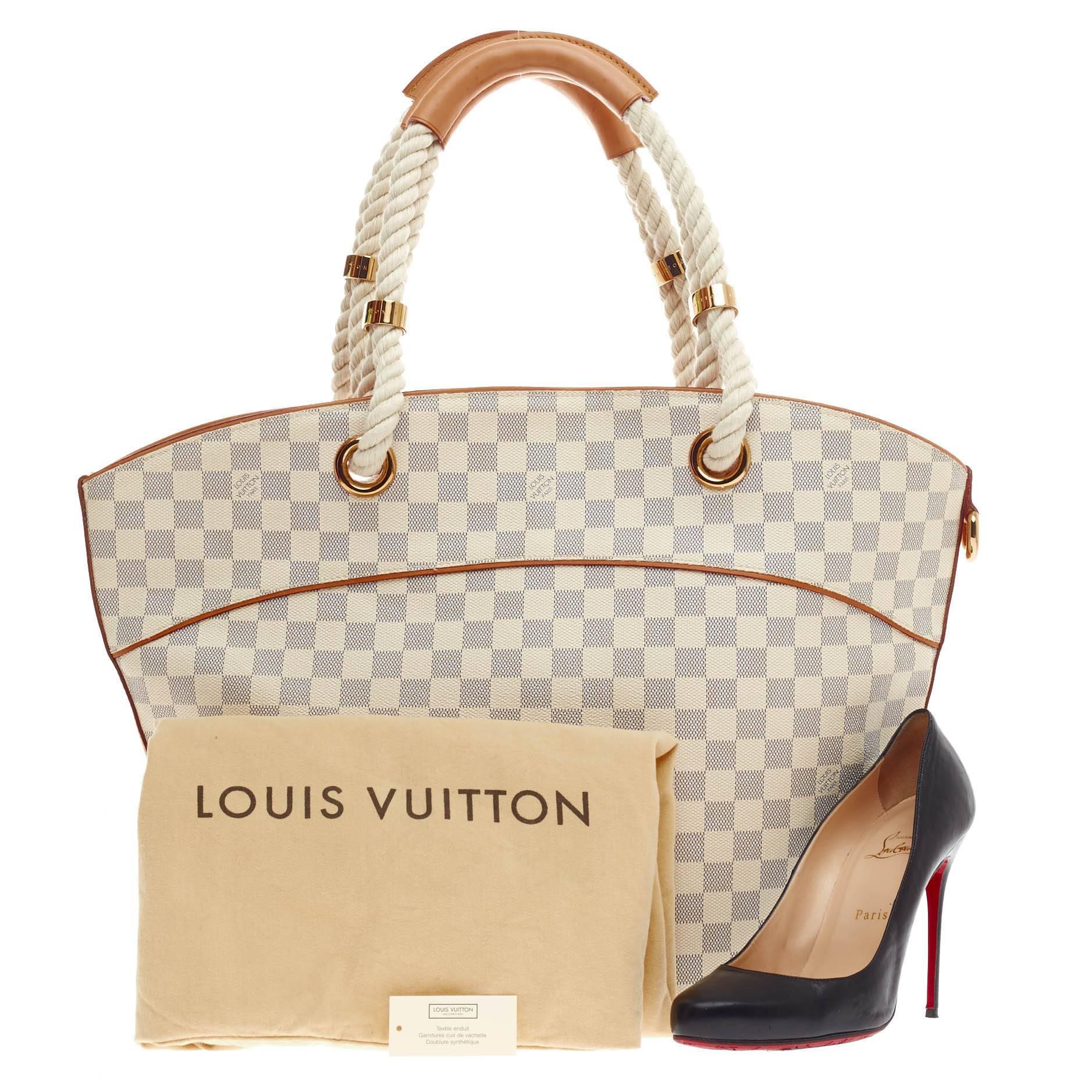 This authentic Louis Vuitton Pampelonne Damier PM aptly named after the Saint Tropez beach is luxurious and sophisticated in design perfect for day travels and light trips. Crafted in Louis Vuitton's signature damier azur canvas with cowhide leather