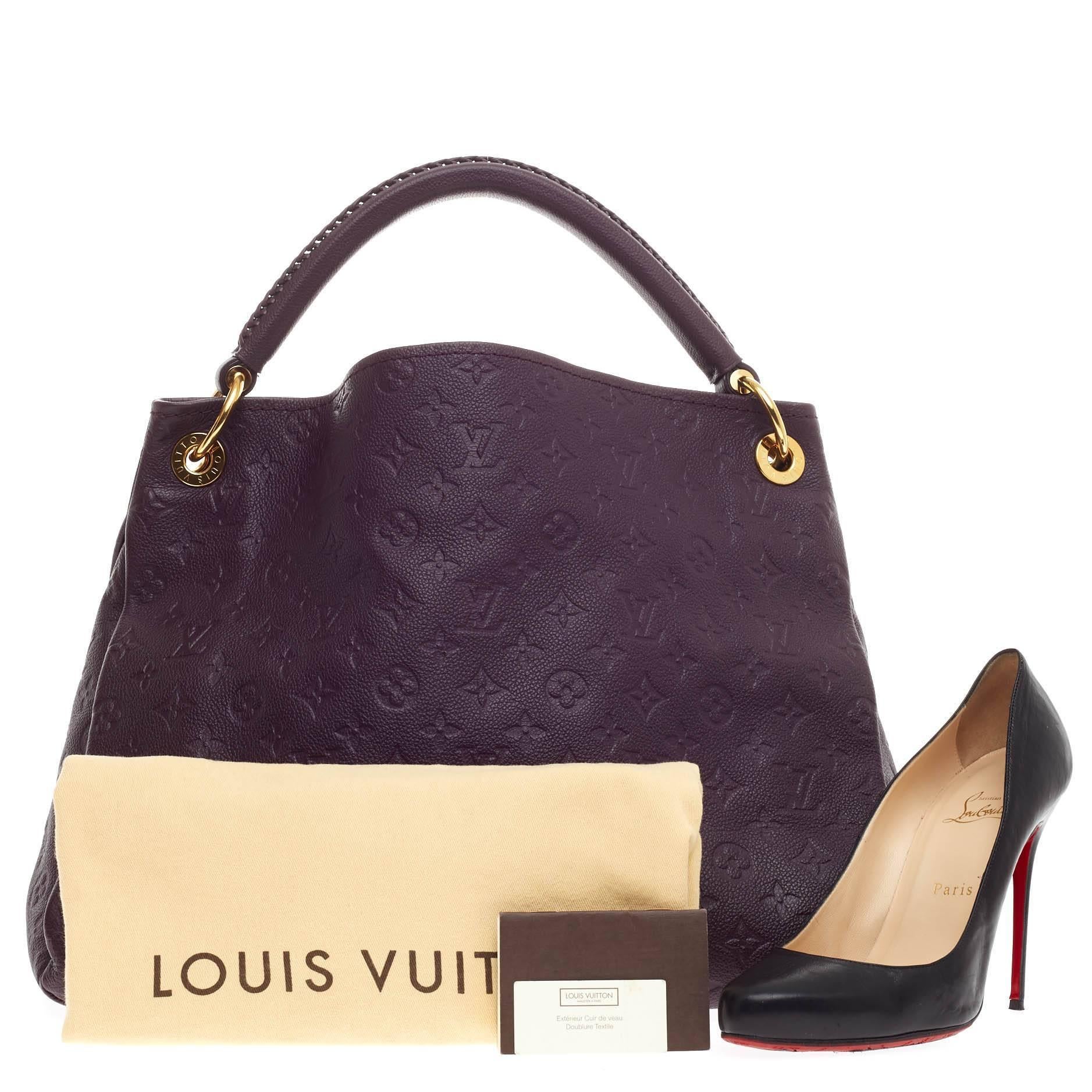 This authentic Louis Vuitton Artsy Monogram Empreinte Leather MM is as elegant as it is sturdy. Crafted in beautiful aube purple embossed leather with subtle LV monogram imprints, this luxurious and refined hobo features a single looped braided top