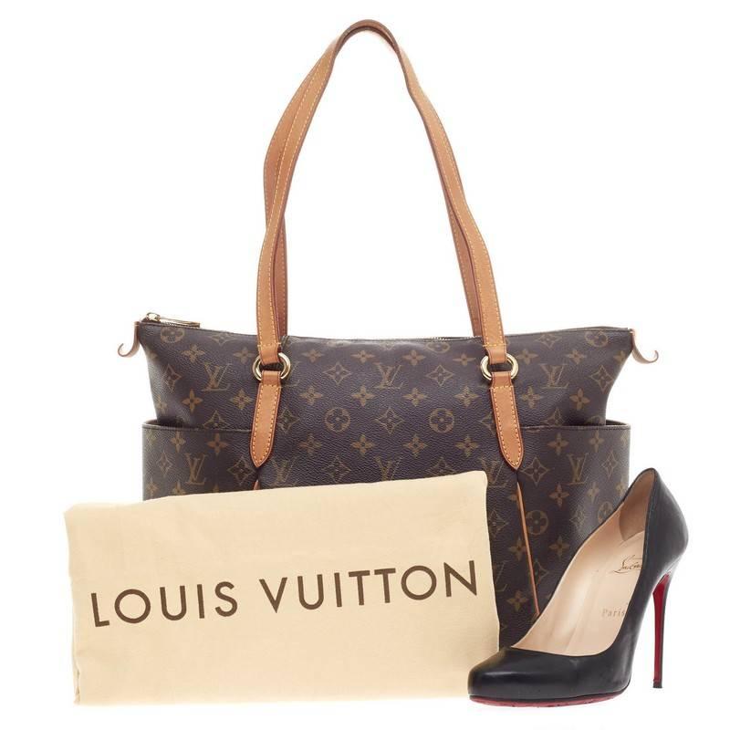 This authentic Louis Vuitton Totally Monogram Canvas MM is a chic and practical bag for everyday occasions. Crafted from Louis Vuitton's iconic monogram print canvas, this simple tote features tall cowhide leather handles and trims, two exterior