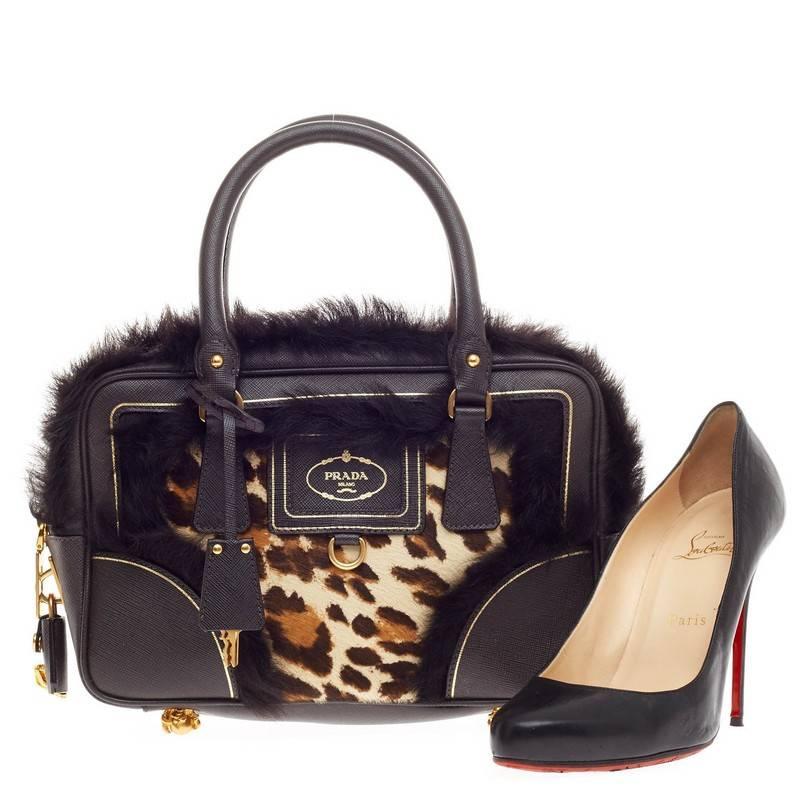 This authentic Prada Clawfoot Satchel Calf Hair and Faux Fur Small is an eye-catching, collector's piece especially made for bold fashionistas. Crafted in leopard print cavallino calf hair with dark brown fur trims and saffiano leather, this daring