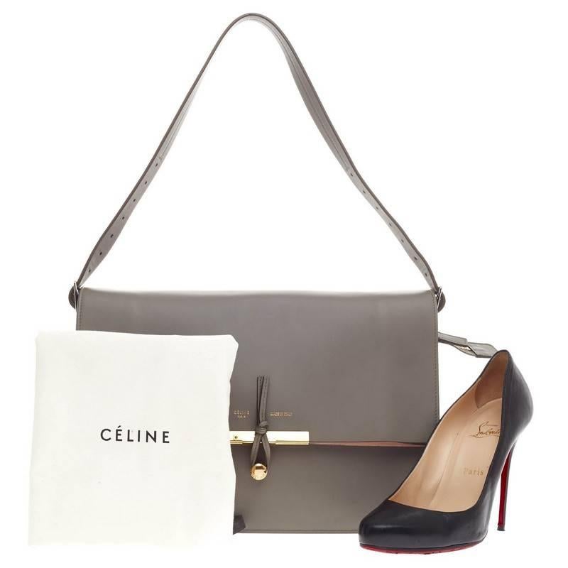 This authentic Celine Clasp Foldover Shoulder Bag Leather Medium presented in the brand's Spring 2011 Collection is an elegant and minimalistic piece made for everyday excursions.Crafted in smooth gray leather, this fold-over flap features an