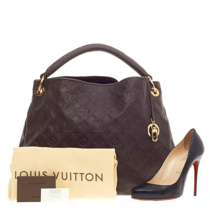 This authentic Louis Vuitton Artsy Monogram Empreinte Leather MM is as elegant as it is sturdy. Crafted in beautiful ombre brown embossed leather with subtle LV monogram imprints, this luxurious and refined hobo features a single looped braided top