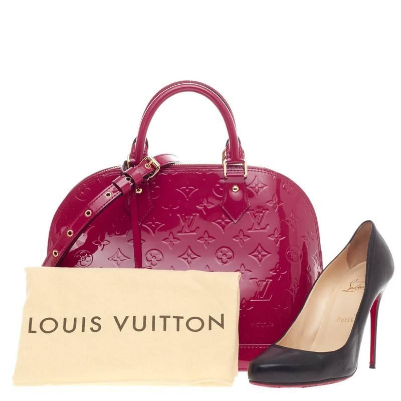 This authentic Louis Vuitton Alma Monogram Vernis PM is a fresh and elegant spin on a classic style that is perfect for all seasons. Crafted from Louis Vuitton's glossy vernis patent leather in Indian rose, this dome-shaped satchel features