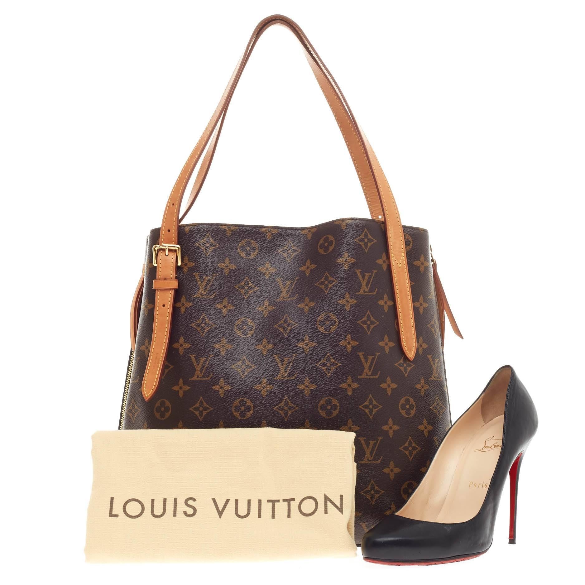 This authentic Louis Vuitton Voltaire Monogram Canvas is elegant and ideal for everyday use. Crafted in brown monogram canvas, this chic, versatile tote features dual vachetta leather slim straps, protective base studs, side zippers which expands