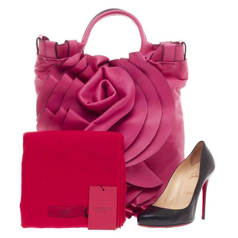This authentic Valentino Rose Vertigo Tote Leather is a fun and eye-catching piece that can glam up your everyday wardrobe. Crafted in luxurious vivid pink nappa calfskin leather, this feminine tote features layers of pink leather to create a