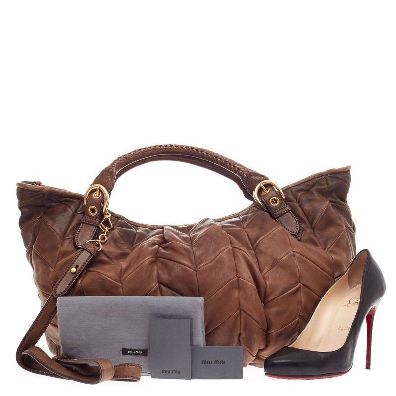 This authentic Miu Miu Convertible Shoulder Bag Chevron Leather Large crafted in distressed shades of brown showcases an industrial yet feminine style made for the woman.. Designed in quilted chevron, this beautiful tote features dual-rolled woven