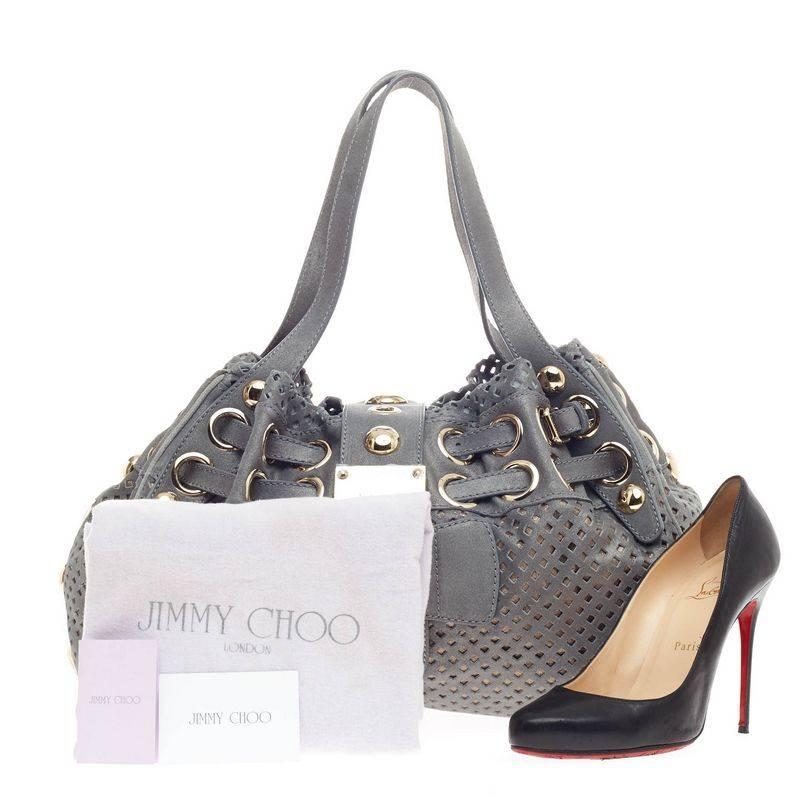 This authentic Jimmy Choo Riki Hobo Perforated Suede in muted blue gray perforated suede showcases a feminine yet stylish bag perfect for the modern woman. This shoulder bag features adjustable straps threaded through oversized grommet rings