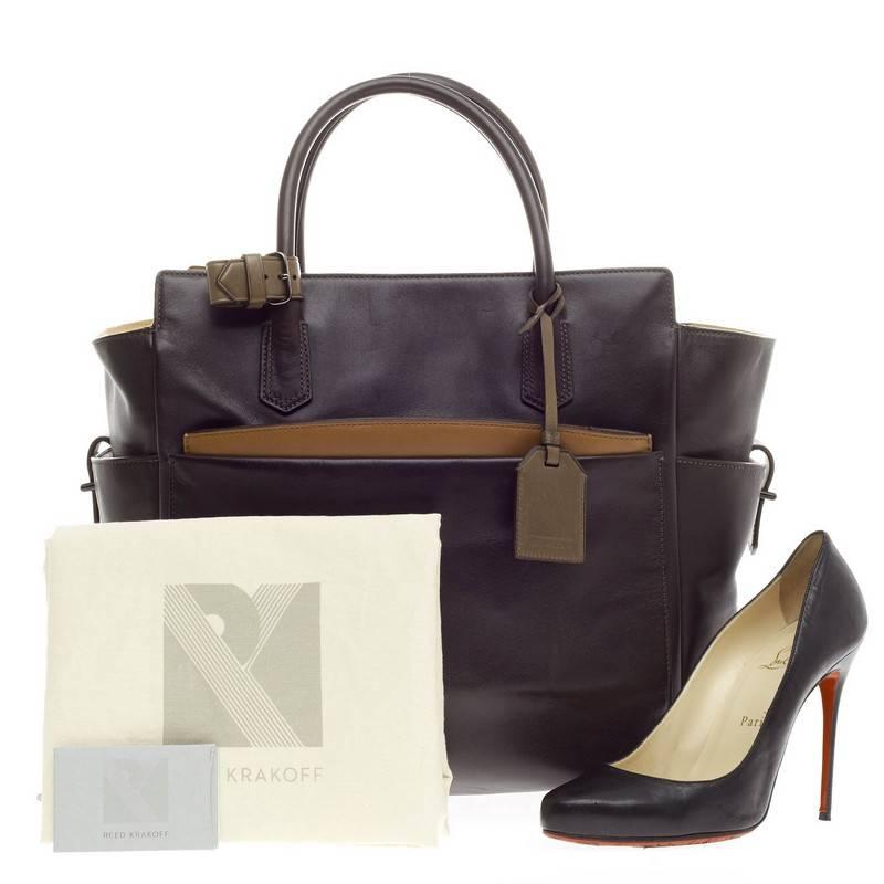 This authentic Reed Krakoff Soft Atlantique Tote Leather in subtle tricolor brown, tan and dark olive accetns exudes a classic yet elegant style is perfect for the modern woman. Designed in soft leather, this sophisticated tote features dual-rolled