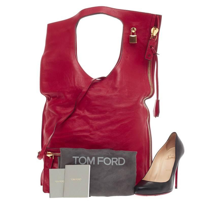 This authentic Tom Ford Alix Fold Over Bag Leather Large from the brand's signature collection showcases a minimalist and functional accessory perfect for the modern woman. Constructed in vivid red lambskin leather with gold-tone hardware accents,