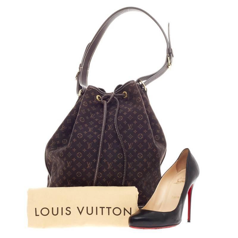 This authentic Louis Vuitton Noe Mini Lin Large is an understated bucket bag made for daily excursions. Crafted in signature dark brown monogram mini lin canvas, this drawstring bag features dark brown leather trims, stand-out contrast stitching,