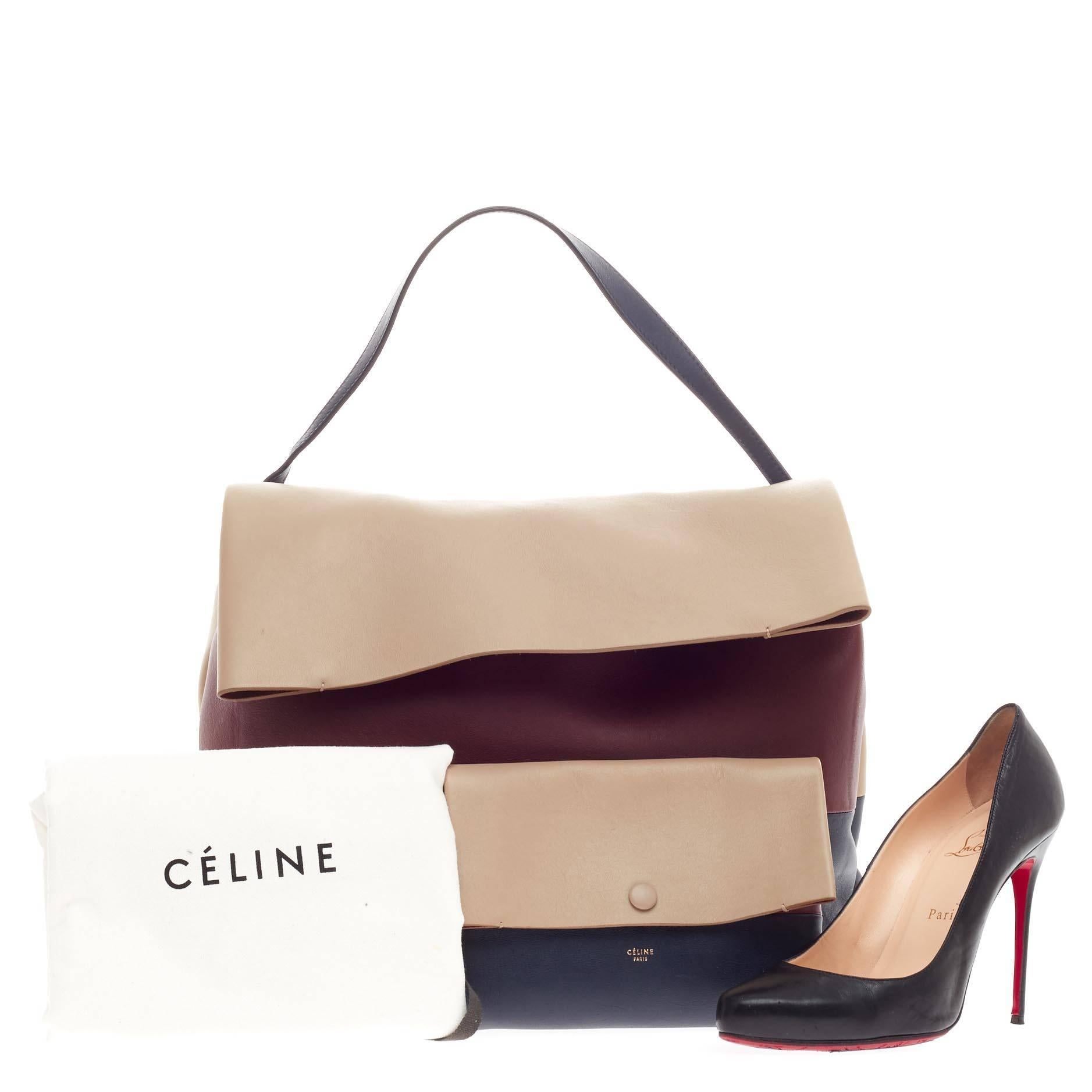This authentic Celine All Soft Tote Leather is a neutral and understated look perfect for the modern woman. Crafted in triad neutral shades of navy blue, maroon and cream leather, this minimalist tote features a single loop leather shoulder strap,