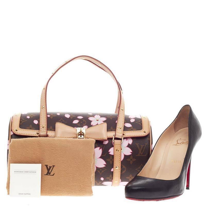 This authentic Louis Vuitton Papillon Limited Edition Cherry Blossom is a coveted bag for a Louis Vuitton collector. Constructed from Louis Vuitton’s signature brown monogram, this handheld baguette features pink flower prints by Japanese pop artist