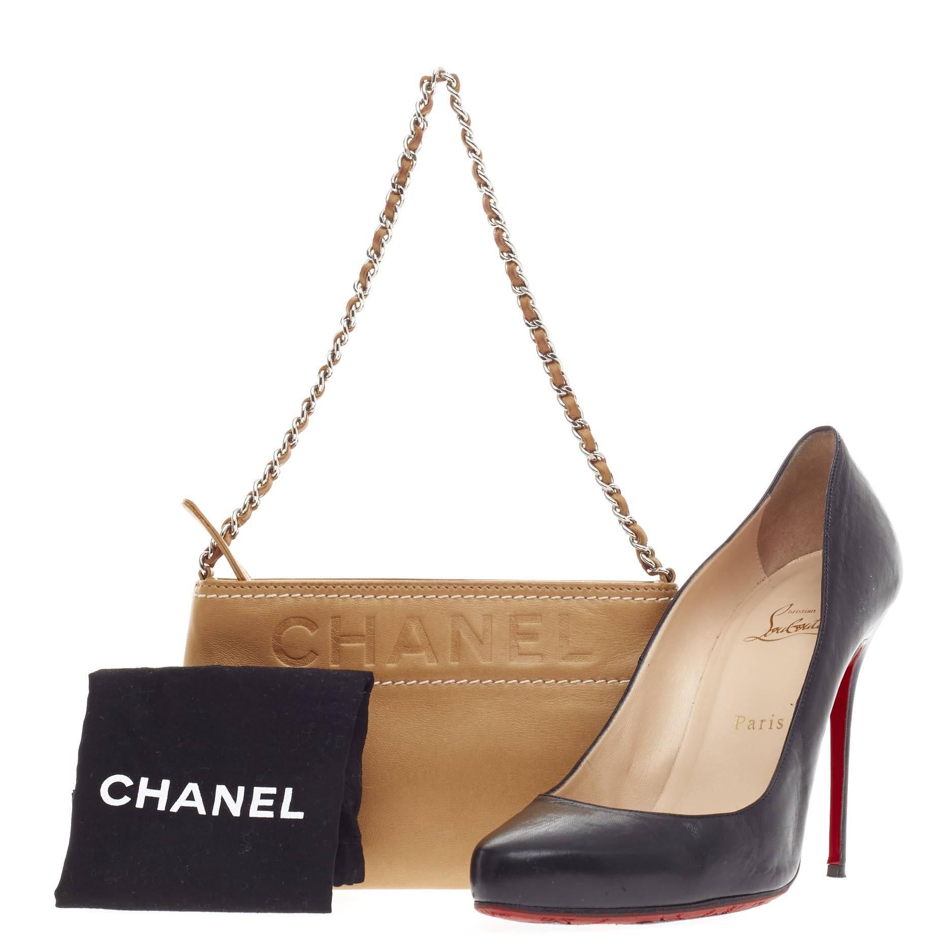 This authentic Chanel Lax Pochette Leather is a classic yet easy style made for the modern woman. Crafted from tan leather, this petite pochette features an embossed Chanel lettering logo at the top, single woven-in leather chain strap, stand-out