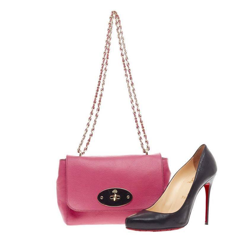 This authentic Mulberry Lily Chain Flap Leather Small showcases the brand's simple, iconic design with a modern twist. Crafted from vibrant fuschia pink leather, this small satchel features woven-in leather chain straps that can be worn short or