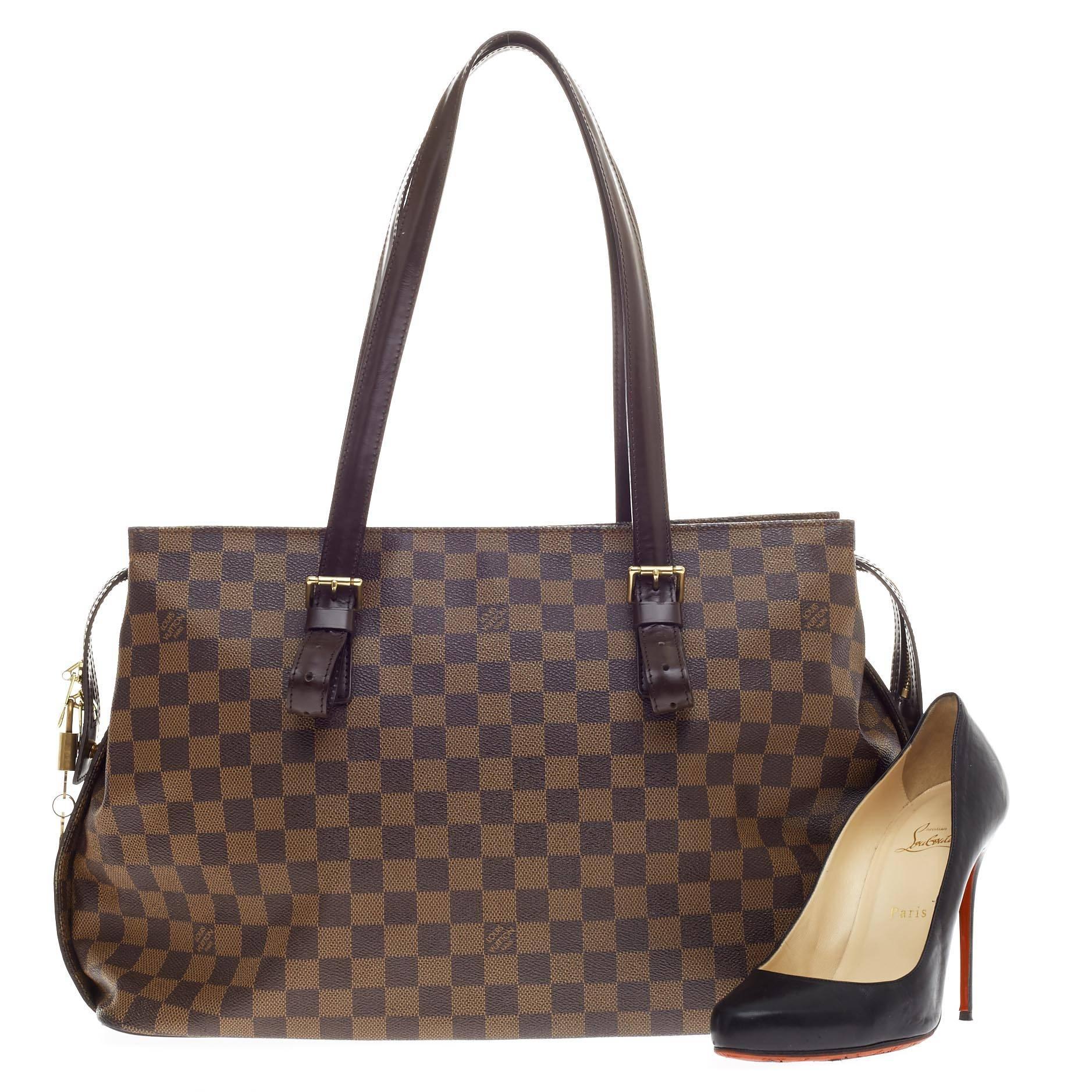 This authentic Louis Vuitton Chelsea Damier combines Louis Vuitton's classic style with sophisticated functionality. Constructed with the classic damier ebene monogram canvas and dark brown leather trims, this coated canvas tote features a simple