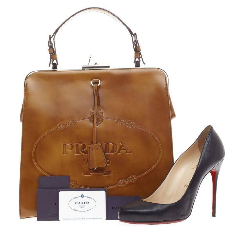 This authentic Prada Frame Handle Bag Spazzolato Leather Small presented in the brand's Fall/Winter 2005 Collection is an iconic piece made for the modern woman. Constructed in brown spazzolato leather with embossed Prada Milano logo at the front,