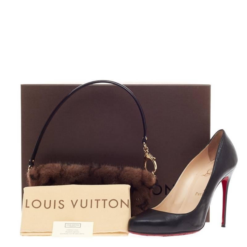 DESCRIPTION 
This authentic Louis Vuitton Milla Pochette Vision Mink MM released in 2009 aptly named after the actress Milla Jovovich is an excellent and chic accessory to carry around during night outs. Crafted from luxurious brown monogram print