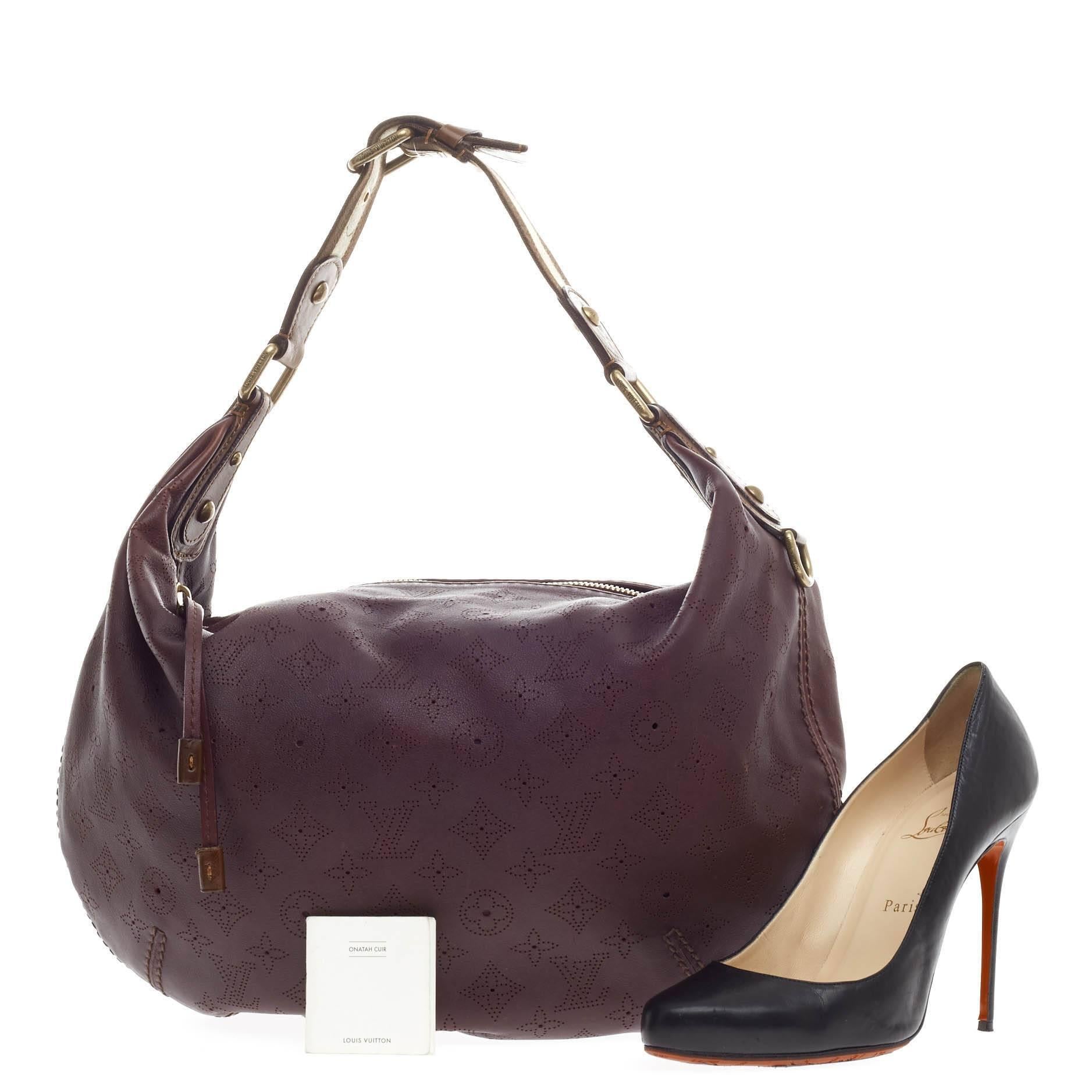 This authentic Louis Vuitton Onatah Hobo Mahina Leather GM is a stylish and functional must-have for LV lovers. Crafted from the brand's signature aubergine purple mahina leather, this hobo features single a subtle perforated monogram design,